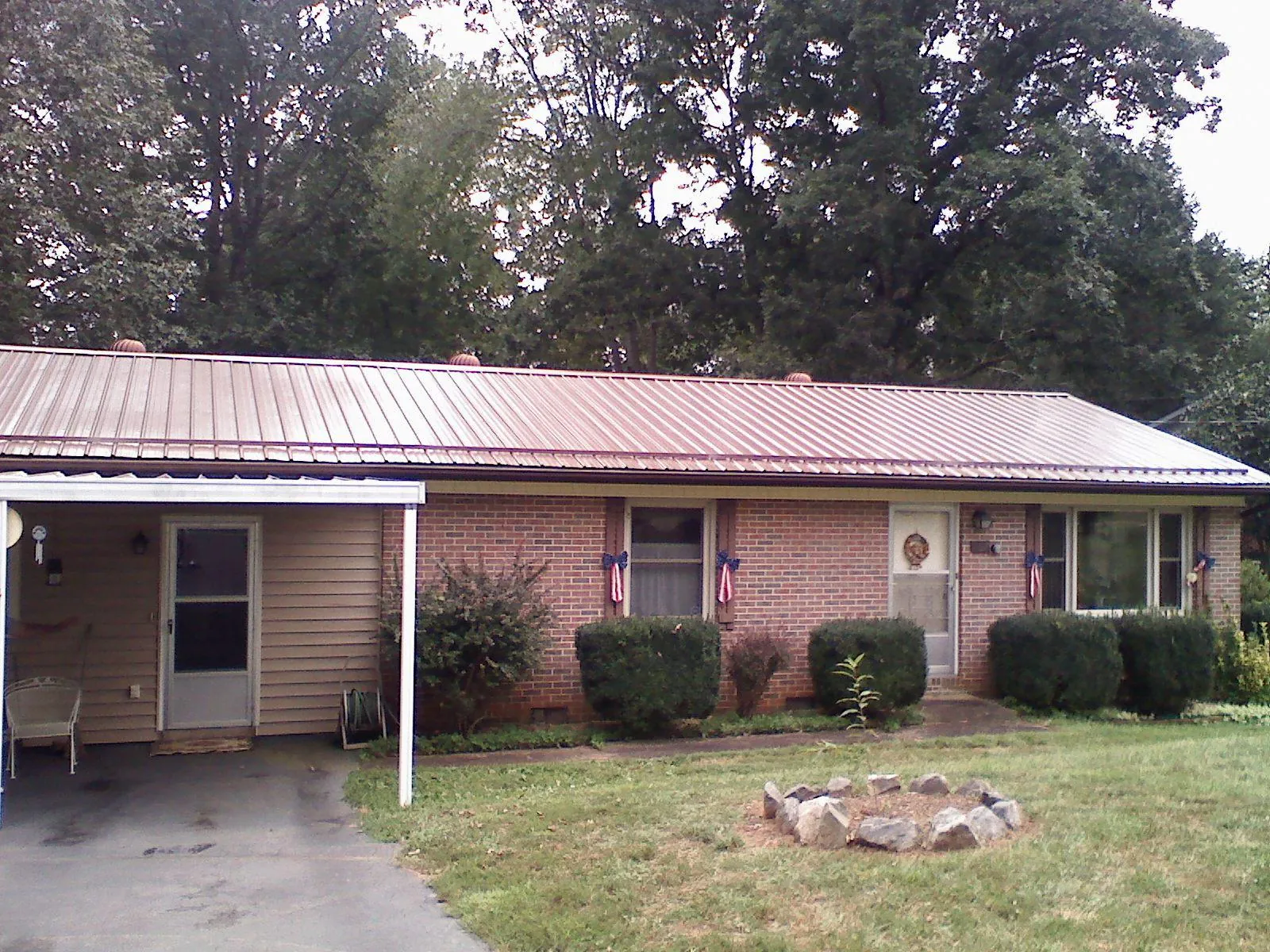 Bronze metal roof and carport on a brick ranch home — Roof Repair work by our crew in Willingboro